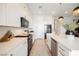 Bright kitchen features white cabinetry, stainless appliances, and island with seating and pendant lighting at 8968 Skye Treeline St, Las Vegas, NV 89166