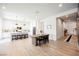 Open-concept kitchen and dining area with hardwood floors and modern decor at 8968 Skye Treeline St, Las Vegas, NV 89166