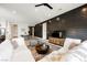 Open-concept living room boasts a plank accent wall and a large sectional sofa at 8968 Skye Treeline St, Las Vegas, NV 89166