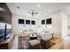 Bright living room with plank accent wall, plush white sectional, and hardwood floors at 8968 Skye Treeline St, Las Vegas, NV 89166