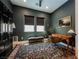 Traditional office space featuring a writing desk, accent rug, black cabinet, and green walls at 8968 Skye Treeline St, Las Vegas, NV 89166