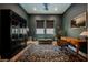 Well-appointed home office with custom millwork, a patterned rug and comfortable seating area at 8968 Skye Treeline St, Las Vegas, NV 89166