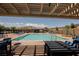 Inviting pool area with lounge chairs under a shaded pergola at 8968 Skye Treeline St, Las Vegas, NV 89166