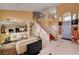 Bright, open living room with tall ceilings, tile floors, staircase, and view into the kitchen at 8983 Emerald Waters Ct, Las Vegas, NV 89147