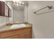 Bathroom featuring a wooden vanity with granite countertop, sink, and a large mirror at 9021 Feather River Ct, Las Vegas, NV 89117