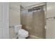 Bathroom showcasing a tiled shower, toilet, and a sliding glass door at 9021 Feather River Ct, Las Vegas, NV 89117