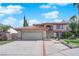 Beautiful two-story home with a red tile roof, large driveway, and two car garage at 9021 Feather River Ct, Las Vegas, NV 89117