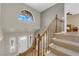 Bright foyer featuring a staircase, large window, and front door at 9021 Feather River Ct, Las Vegas, NV 89117