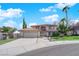 Beautiful two-story home with a well-manicured lawn, mature trees, and a tile roof at 9021 Feather River Ct, Las Vegas, NV 89117