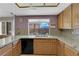 Galley kitchen featuring granite countertops and light wood cabinets at 9021 Feather River Ct, Las Vegas, NV 89117