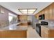 Traditional kitchen features granite counters, bright light fixture, and stainless steel refrigerator at 9021 Feather River Ct, Las Vegas, NV 89117