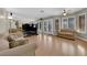 Open living room featuring wood floors, large windows and an adjacent kitchen area, perfect for entertaining at 9021 Feather River Ct, Las Vegas, NV 89117