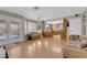 Open living room featuring wood floors, large windows and an adjacent kitchen area, perfect for entertaining at 9021 Feather River Ct, Las Vegas, NV 89117