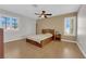 Neutral main bedroom boasts a ceiling fan, plantation shutters, and wood-look floors at 9021 Feather River Ct, Las Vegas, NV 89117