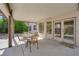 This is a backyard patio with a table and chairs underneath a covered overhang at 9021 Feather River Ct, Las Vegas, NV 89117