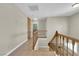 Staircase with wood railing leading to the second floor landing at 9021 Feather River Ct, Las Vegas, NV 89117