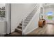 Foyer area with staircase, wood floors, modern table, and a view to the front door at 9674 Biedler Ct # Lot 10, Las Vegas, NV 89178