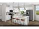 Modern kitchen with white cabinets, stainless steel appliances, and a center island with seating at 9674 Biedler Ct # Lot 10, Las Vegas, NV 89178