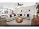 Open-concept living room with neutral decor, hardwood flooring, and adjacent kitchen and dining areas at 9674 Biedler Ct # Lot 10, Las Vegas, NV 89178