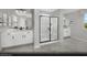 Bright bathroom featuring double vanity, walk-in glass shower, and modern fixtures at 9674 Biedler Ct # Lot 10, Las Vegas, NV 89178