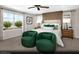 A relaxing bedroom featuring a large window, two green chairs, and decor accents at 9674 Biedler Ct # Lot 10, Las Vegas, NV 89178