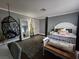 Stylish bedroom featuring a chic hanging chair, plush rug, and modern decor at , Henderson, NV 89015