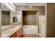 Bright bathroom featuring double sinks, a bathtub, and a standing shower at 10001 Peace Way # 1341, Las Vegas, NV 89147