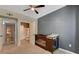 Well-lit bedroom featuring an adjoining bathroom and a ceiling fan at 10001 Peace Way # 1341, Las Vegas, NV 89147