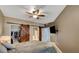 Cozy bedroom featuring sliding barn doors, ceiling fan, and mounted TV at 10001 Peace Way # 1341, Las Vegas, NV 89147