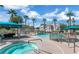 Community pool and hot tub area with cabanas, lounge chairs, and lush palm trees at 10001 Peace Way # 1341, Las Vegas, NV 89147