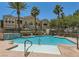 Community pool with a waterfall feature, lounge chairs and surrounding landscape under a sunny sky at 10001 Peace Way # 1341, Las Vegas, NV 89147