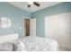 Charming bedroom features blue walls, plush bedding, a ceiling fan, closet, and ensuite bath access at 10191 Deerfield Beach Ave # 202, Las Vegas, NV 89129