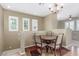 Charming dining area with a decorative chandelier, seating for four, and plantation shutters at 10191 Deerfield Beach Ave # 202, Las Vegas, NV 89129