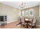 Inviting dining room with a chandelier, hardwood floors, and ample natural light at 10191 Deerfield Beach Ave # 202, Las Vegas, NV 89129