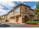 Inviting condo exterior featuring a well-manicured lawn and private garages at 10191 Deerfield Beach Ave # 202, Las Vegas, NV 89129
