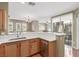 Open-concept kitchen with wooden cabinets, stainless steel appliances, and a breakfast bar for casual dining at 10191 Deerfield Beach Ave # 202, Las Vegas, NV 89129