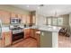 Well-lit kitchen with stainless steel appliances and a connected dining area at 10191 Deerfield Beach Ave # 202, Las Vegas, NV 89129