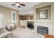 Cozy living area with a fireplace, mounted television, and an open view to the kitchen at 10191 Deerfield Beach Ave # 202, Las Vegas, NV 89129