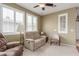 Comfortable living room with large windows, a ceiling fan, and neutral decor at 10191 Deerfield Beach Ave # 202, Las Vegas, NV 89129