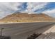 Desert mountain view from the street showcasing the natural beauty surrounding the community at 10191 Deerfield Beach Ave # 202, Las Vegas, NV 89129