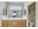 Bright bathroom featuring a double sink vanity with wood cabinets and a separate shower room at 10553 Pine Pointe Ave # 203, Las Vegas, NV 89144