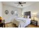 Inviting bedroom with hardwood floors, ceiling fan and decorative accents at 10553 Pine Pointe Ave # 203, Las Vegas, NV 89144