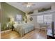 Cozy bedroom with hardwood floors, a ceiling fan, and a decorative shelf with plant accents at 10553 Pine Pointe Ave # 203, Las Vegas, NV 89144