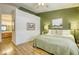 Comfortable bedroom with hardwood floors that connects to the bathroom and has a large bed at 10553 Pine Pointe Ave # 203, Las Vegas, NV 89144