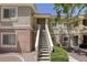 Exterior view showcasing the entrance stairs and a neatly landscaped surrounding of the building at 10553 Pine Pointe Ave # 203, Las Vegas, NV 89144
