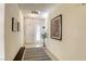 Bright hallway with tile floors and recessed lighting leads to the front door, with bench seating at 10553 Pine Pointe Ave # 203, Las Vegas, NV 89144