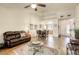 Bright living room boasts hardwood floors, ceiling fan, and open layout into the dining area and kitchen at 10553 Pine Pointe Ave # 203, Las Vegas, NV 89144