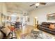 Open-concept living room and dining area with hardwood floors, natural light, and comfortable seating at 10553 Pine Pointe Ave # 203, Las Vegas, NV 89144