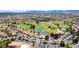 A scenic aerial view of a golf course community with manicured green spaces, ponds and beautiful homes at 10557 Shoalhaven Dr, Las Vegas, NV 89134