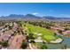 An aerial shot of a golf course community featuring lush fairways, sand traps, and mountain views at 10557 Shoalhaven Dr, Las Vegas, NV 89134